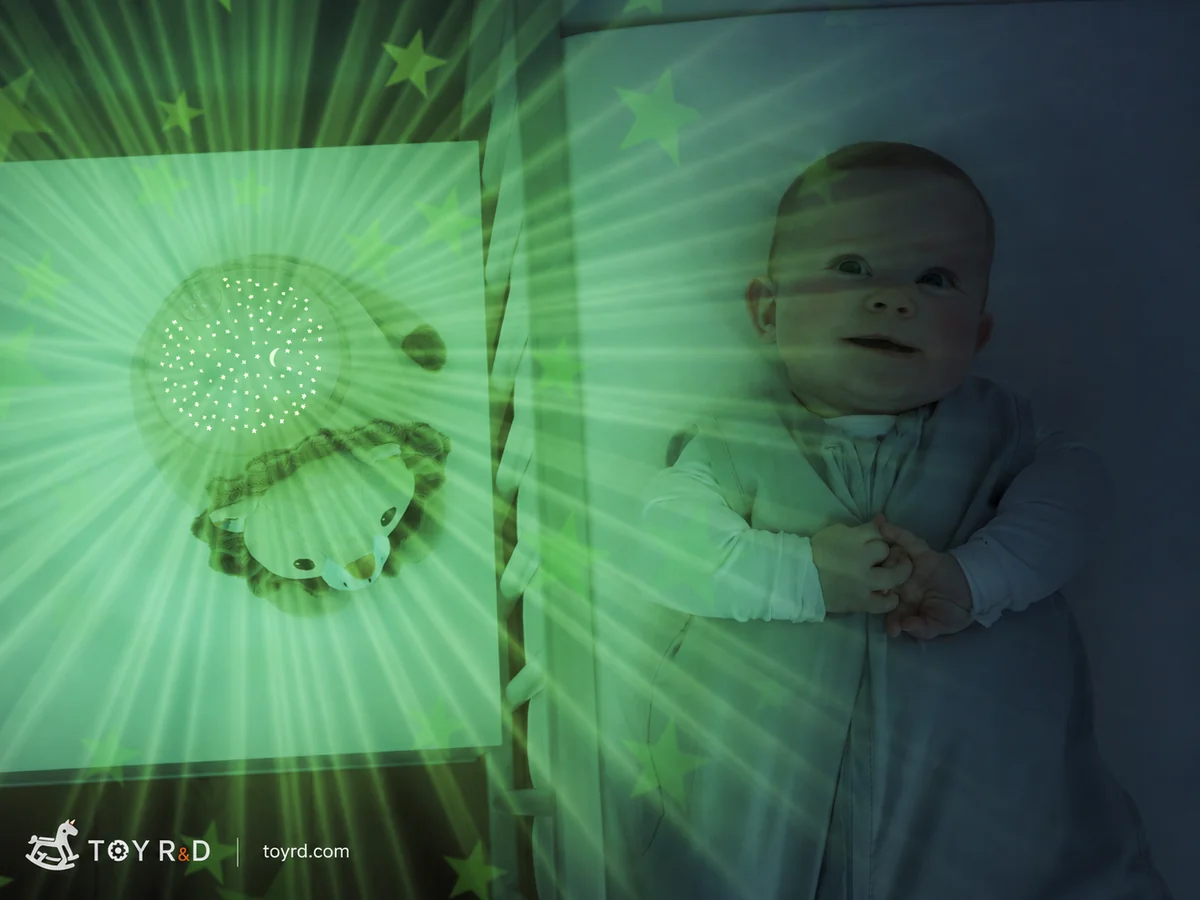 A star-projector toy casting stars across a child's sleeping space